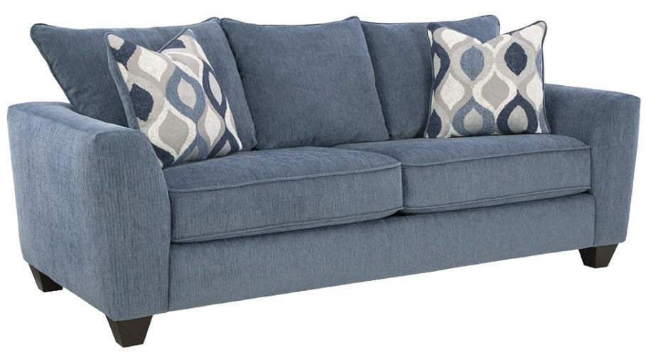 Front-angle studio shot of the Albany denim blue fabric sofa, showcasing its texture and patterned accent pillows.