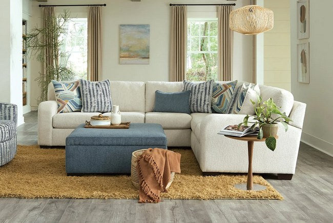 Inviting full front view of the L-shape sectional in a neutral beige, showcasing its modern design and plush cushions in a bright, airy living space.