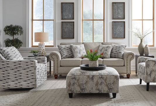 Front-angle lifestyle view of the Fusion PATIGLASS Cocktail Ottoman, positioned as a centerpiece in a modern living room setting.