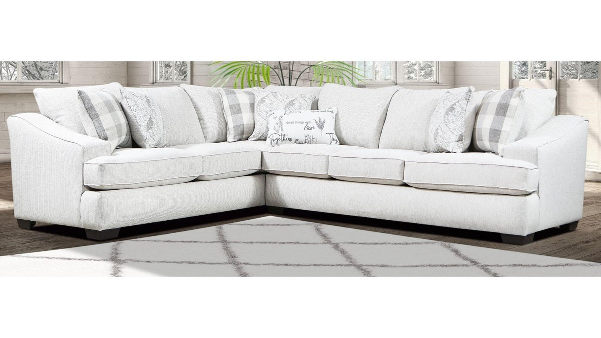 {'index': 2, 'type': 'main', 'description': 'Full view of a light-colored, L-shaped sectional sofa in a bright living room setting, showcasing its modern design and accent pillows.'}
