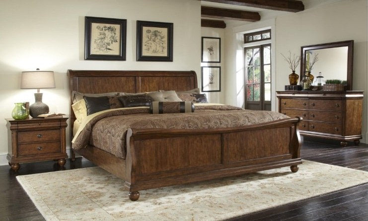 Full view of the traditional bedroom set, showcasing the sleigh bed, nightstand, and dresser with mirror, all in a rich, warm brown wood finish.