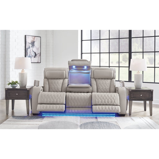 Full front view of the power reclining sofa in a modern living room setting, showcasing its LED lighting and open console.