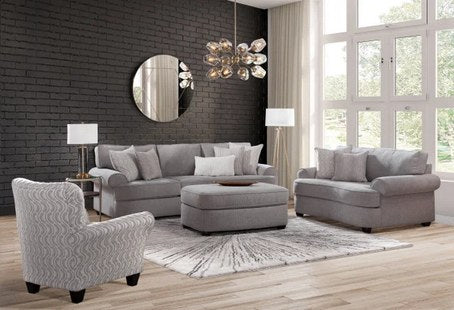Primary view of the living room set, showcasing the patterned accent chair, sofa, and ottoman in a modern setting.