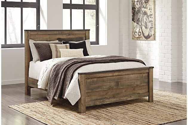 Full front view of the Ashley B446-87 bed frame, showcasing its rustic design and distressed wood finish within a bright, contemporary bedroom setting.