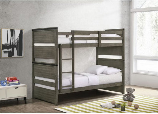 Full front view of the Elements International Twin Over Twin Bunk Bed, showcasing its rustic gray finish, ladder, and overall modern industrial design in a styled room.