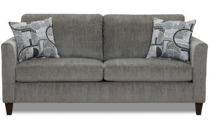 Close-up of the left armrest and an abstract patterned throw pillow, highlighting the sofa's style and fabric texture.