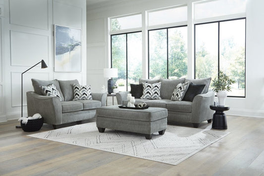 Full view of the American Furniture sofa, coordinating loveseat, and ottoman, arranged in a bright, modern transitional living room setting.
