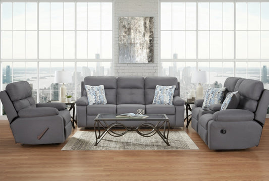 Grey fabric rocker recliner displayed with matching reclining sofa and console loveseat in a bright, modern living room.